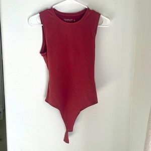 Abercrombie & Fitch bodysuit in size small. Sleeveless in a rust color.